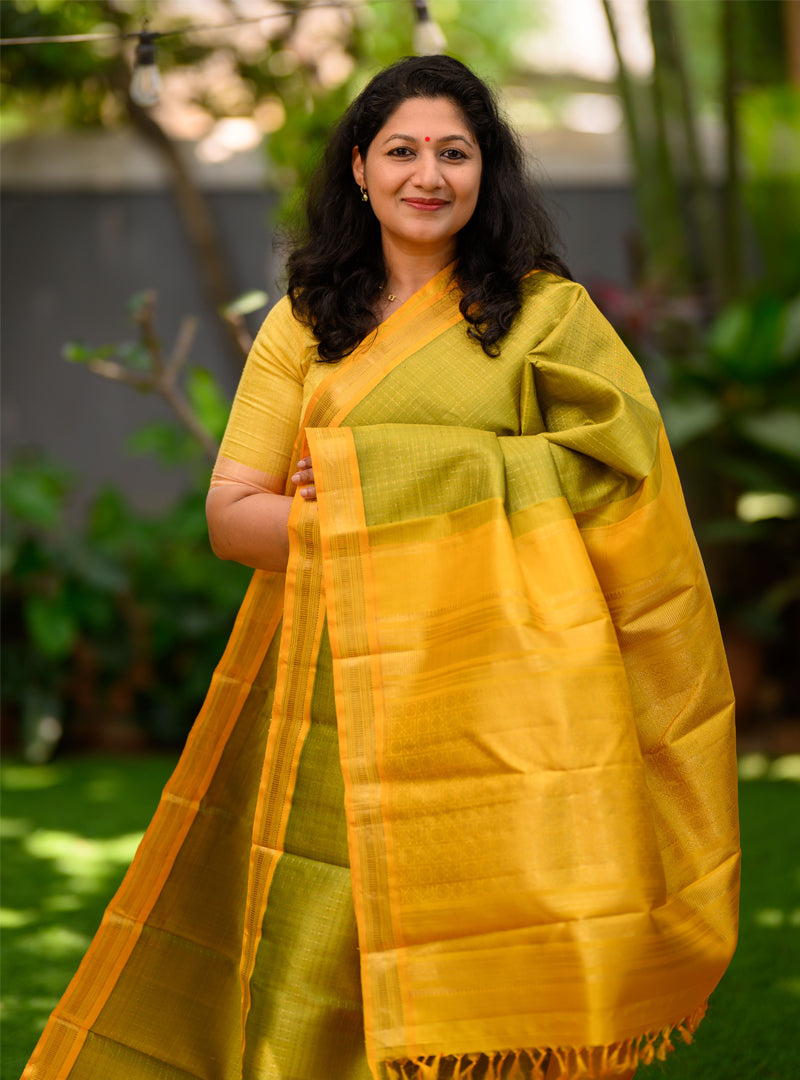 A Vintage plus butta kanchivaram in light Green and yellow.