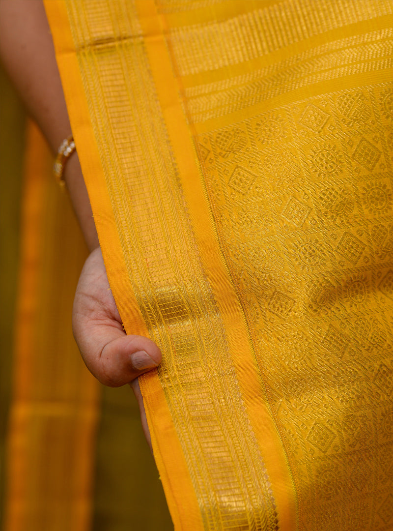 A Vintage plus butta kanchivaram in light Green and yellow.