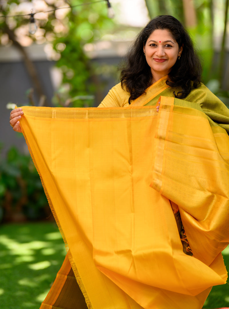 A Vintage plus butta kanchivaram in light Green and yellow.