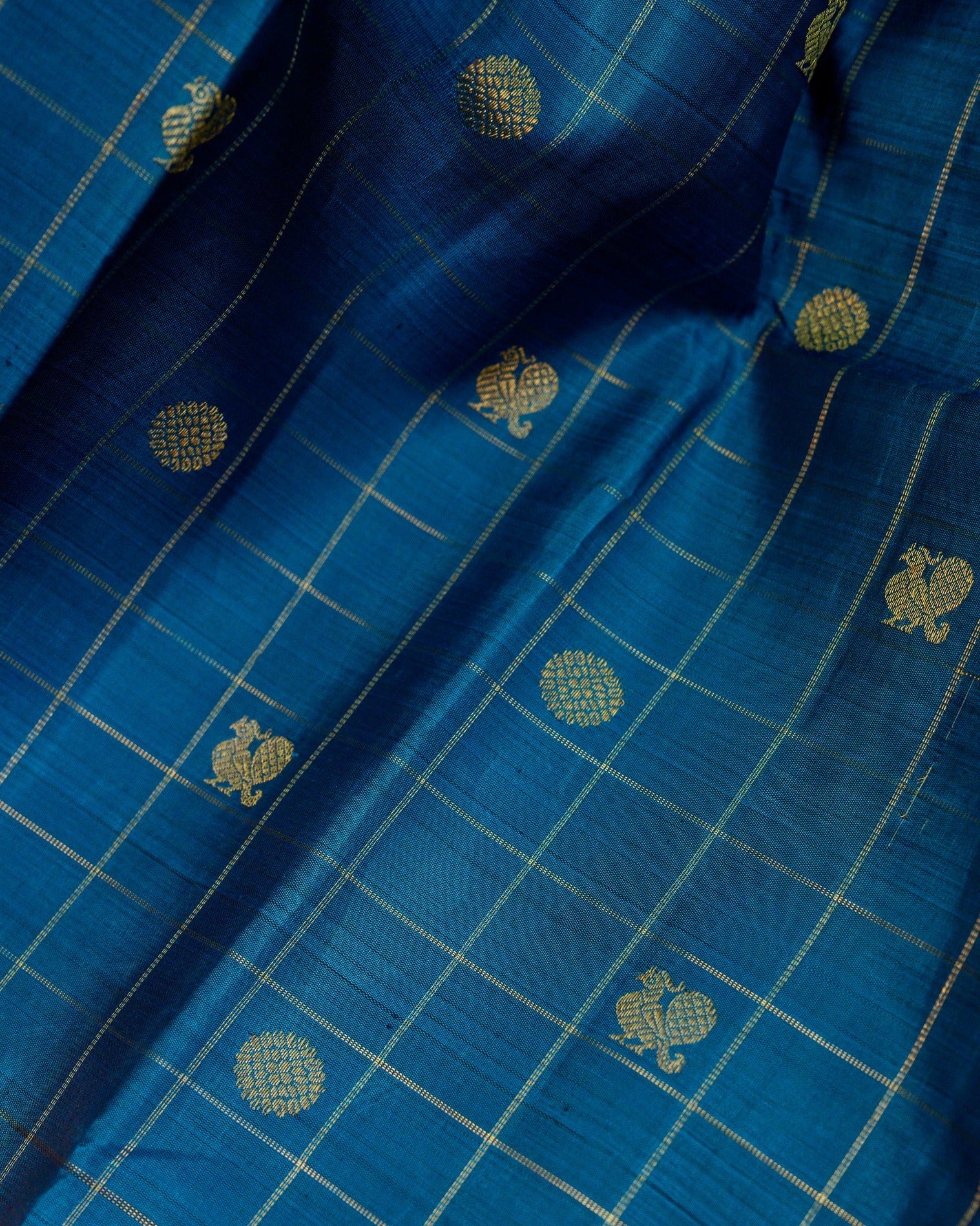 A striking zari kattam Kanjivaram in a rich teal blue and magenta combination.