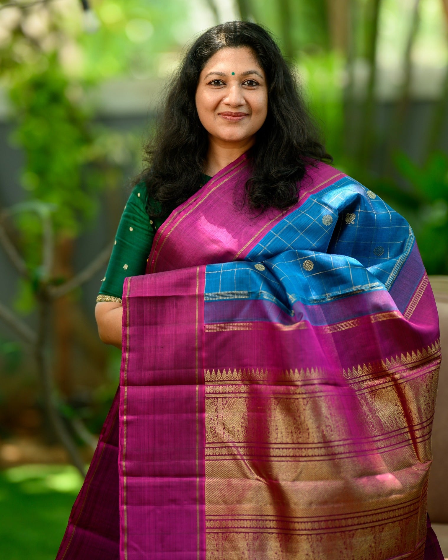 A striking zari kattam Kanjivaram in a rich teal blue and magenta combination.