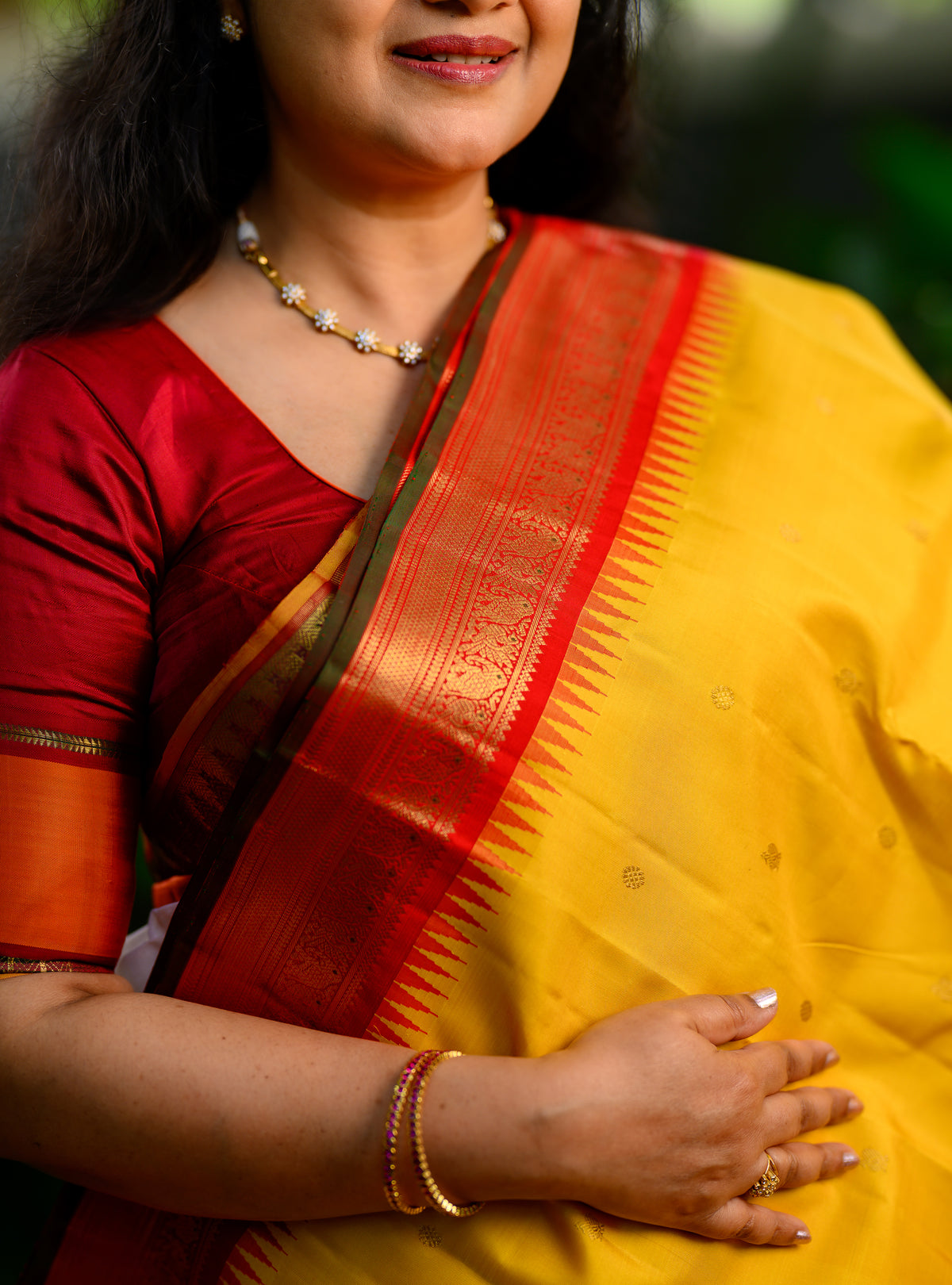 Pure silk, pure zari Korvai Kanchivaram in a beautiful turmeric yellow body, featuring elegant peacock and tiny Kamalam buttas.