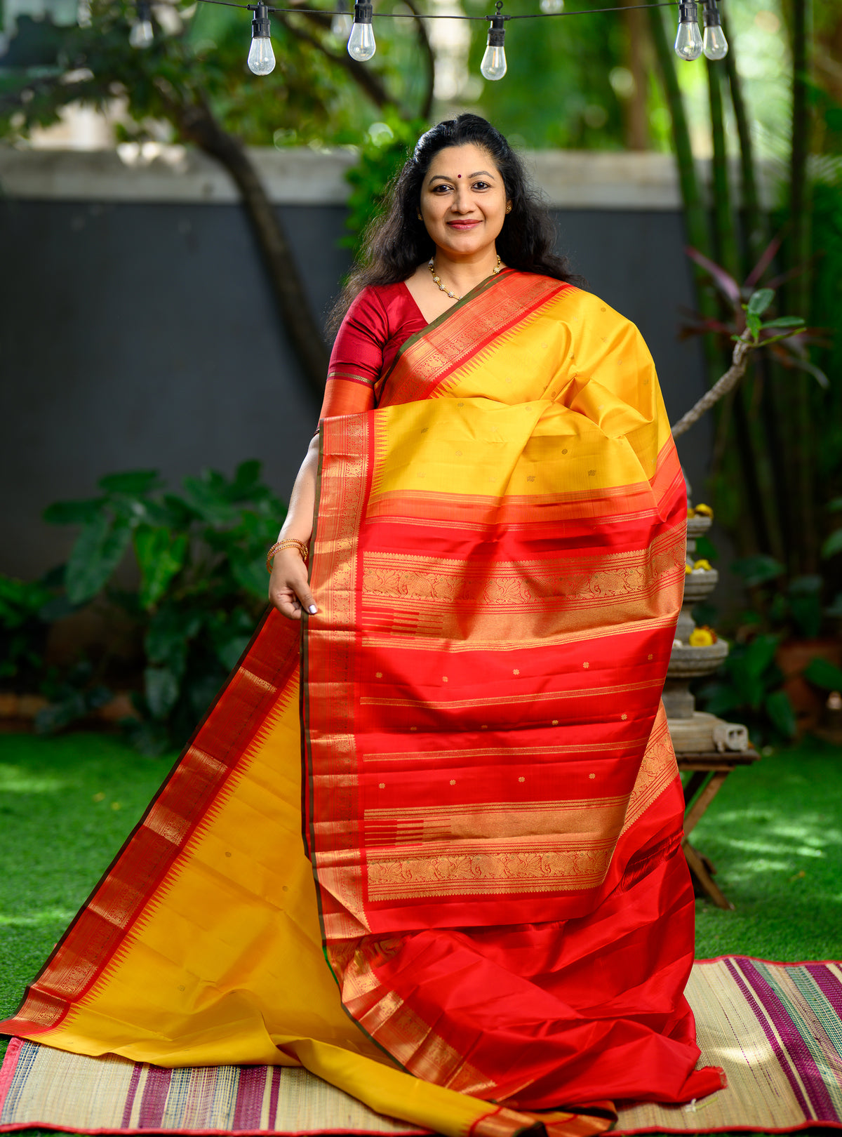 Pure silk, pure zari Korvai Kanchivaram in a beautiful turmeric yellow body, featuring elegant peacock and tiny Kamalam buttas.