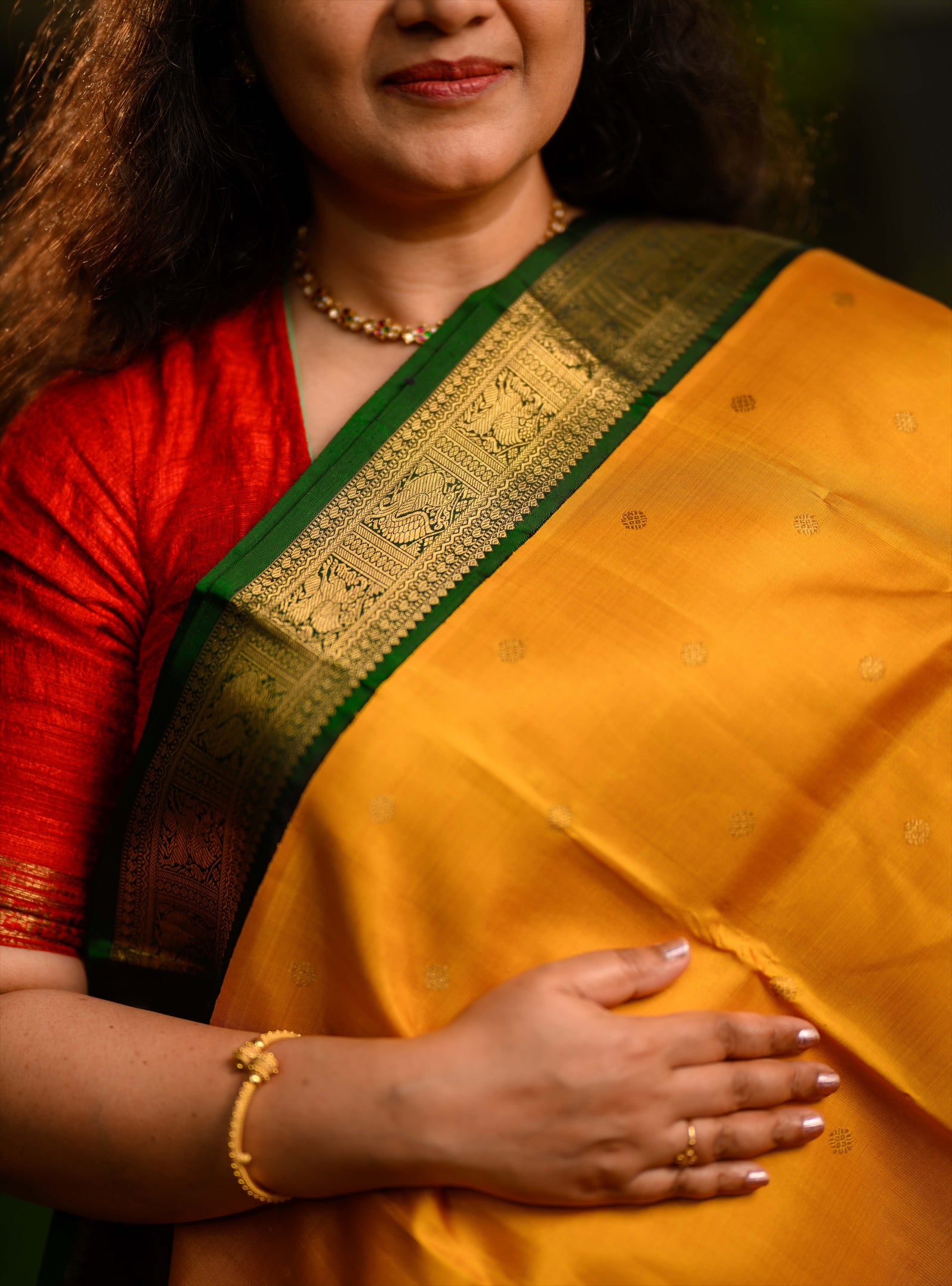A beautiful pure silk, pure zari korvai kanjivaram in an evergreen combination of turmeric yellow body and emerald green border.