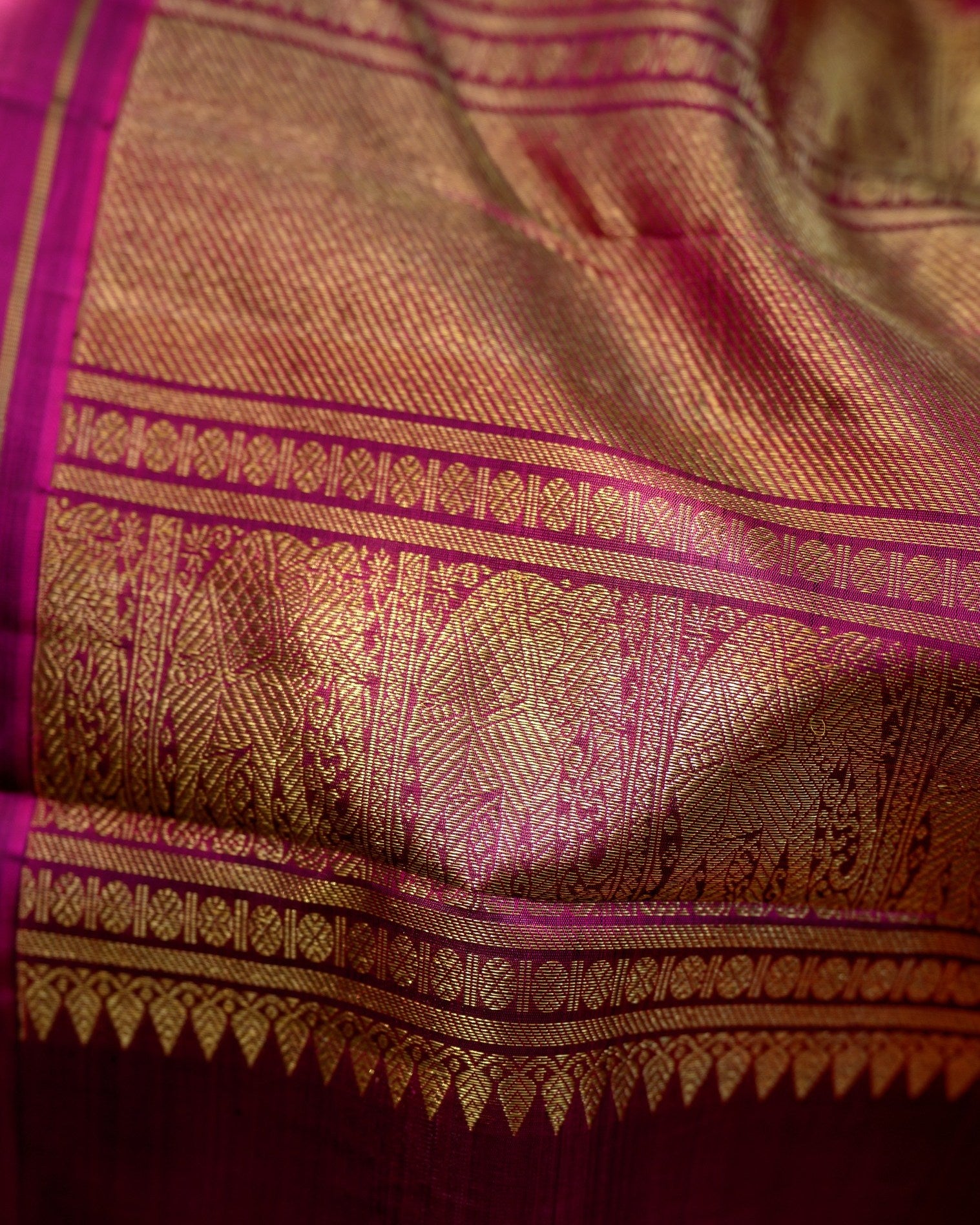 A striking zari kattam Kanjivaram in a rich teal blue and magenta combination.