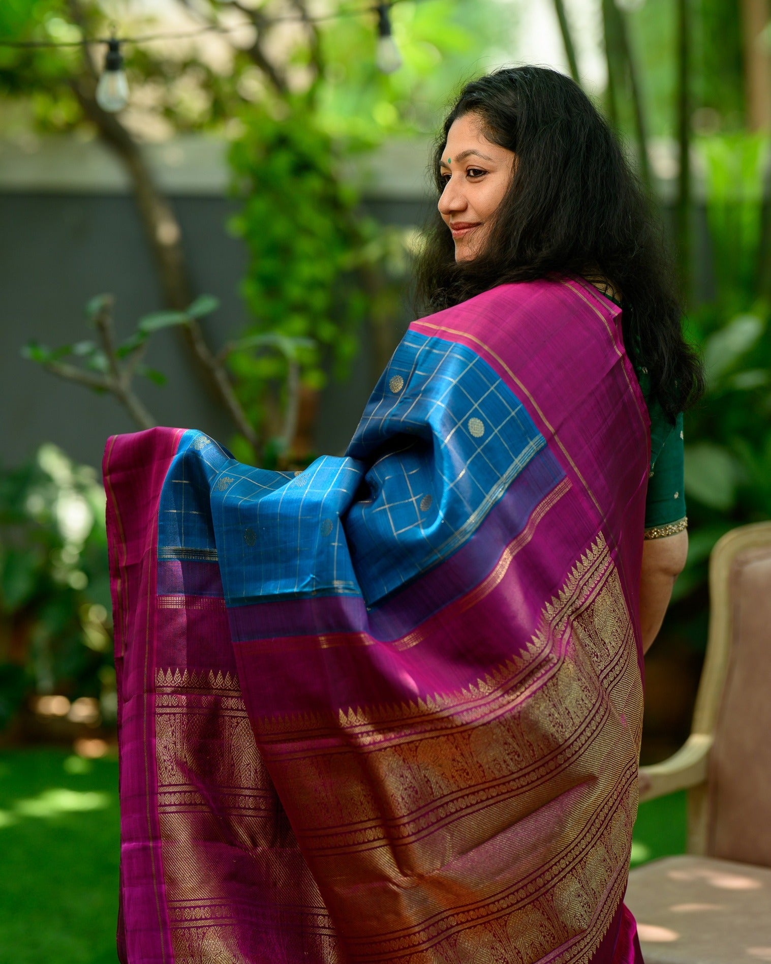 A striking zari kattam Kanjivaram in a rich teal blue and magenta combination.