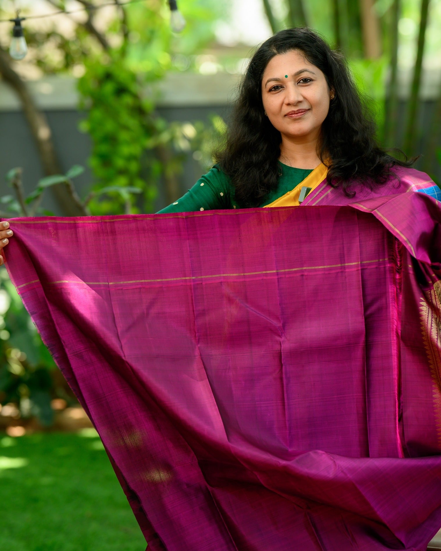 A striking zari kattam Kanjivaram in a rich teal blue and magenta combination.