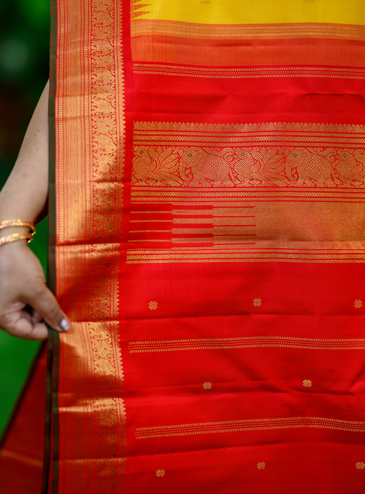 Pure silk, pure zari Korvai Kanchivaram in a beautiful turmeric yellow body, featuring elegant peacock and tiny Kamalam buttas.