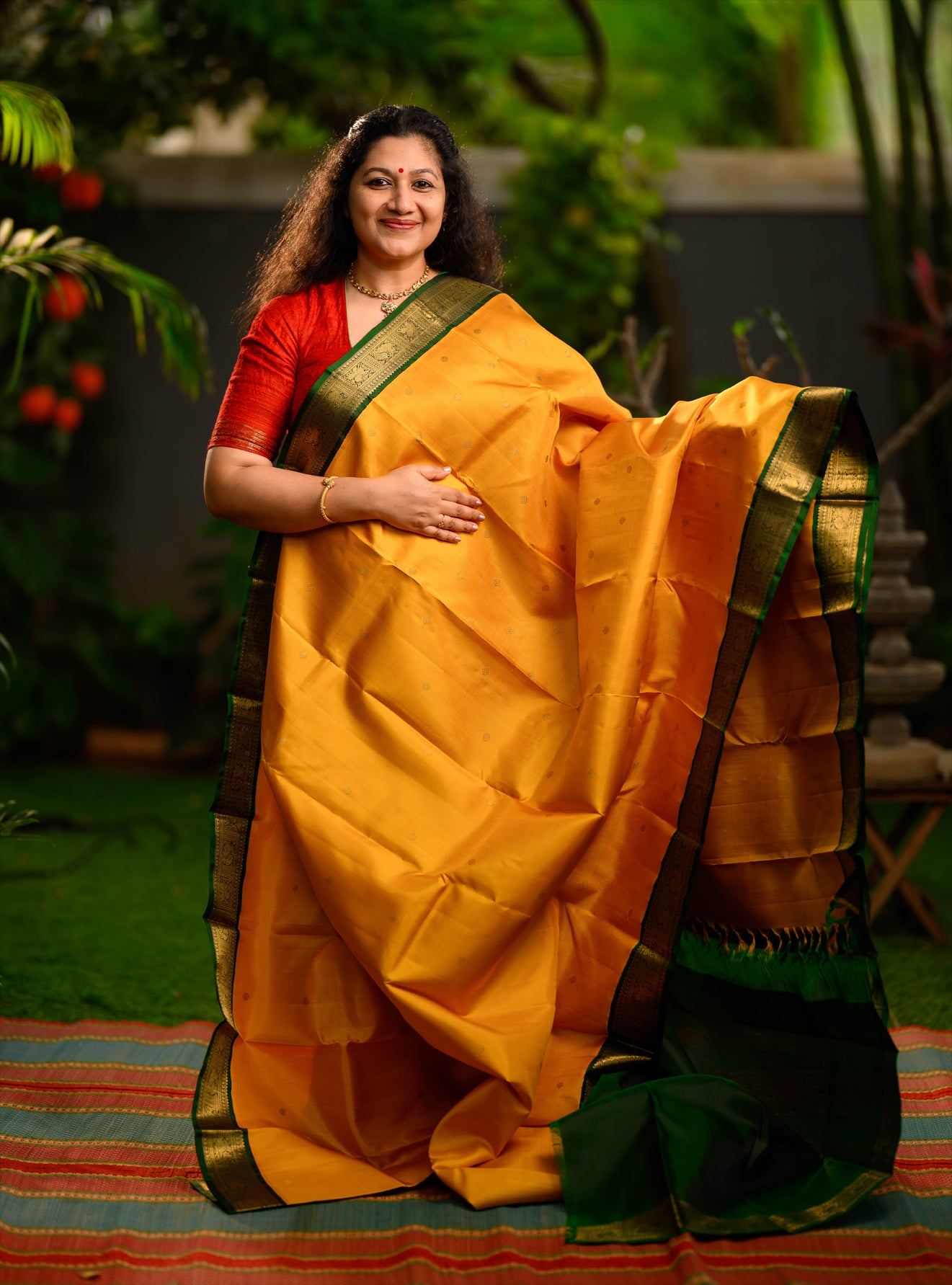 A beautiful pure silk, pure zari korvai kanjivaram in an evergreen combination of turmeric yellow body and emerald green border.