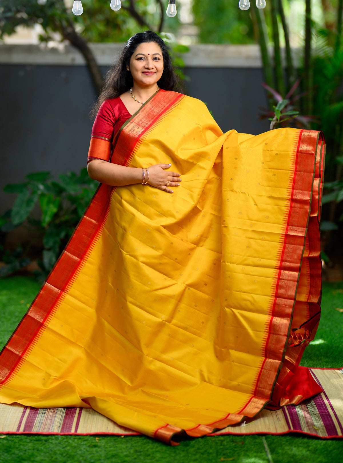Pure silk, pure zari Korvai Kanchivaram in a beautiful turmeric yellow body, featuring elegant peacock and tiny Kamalam buttas.