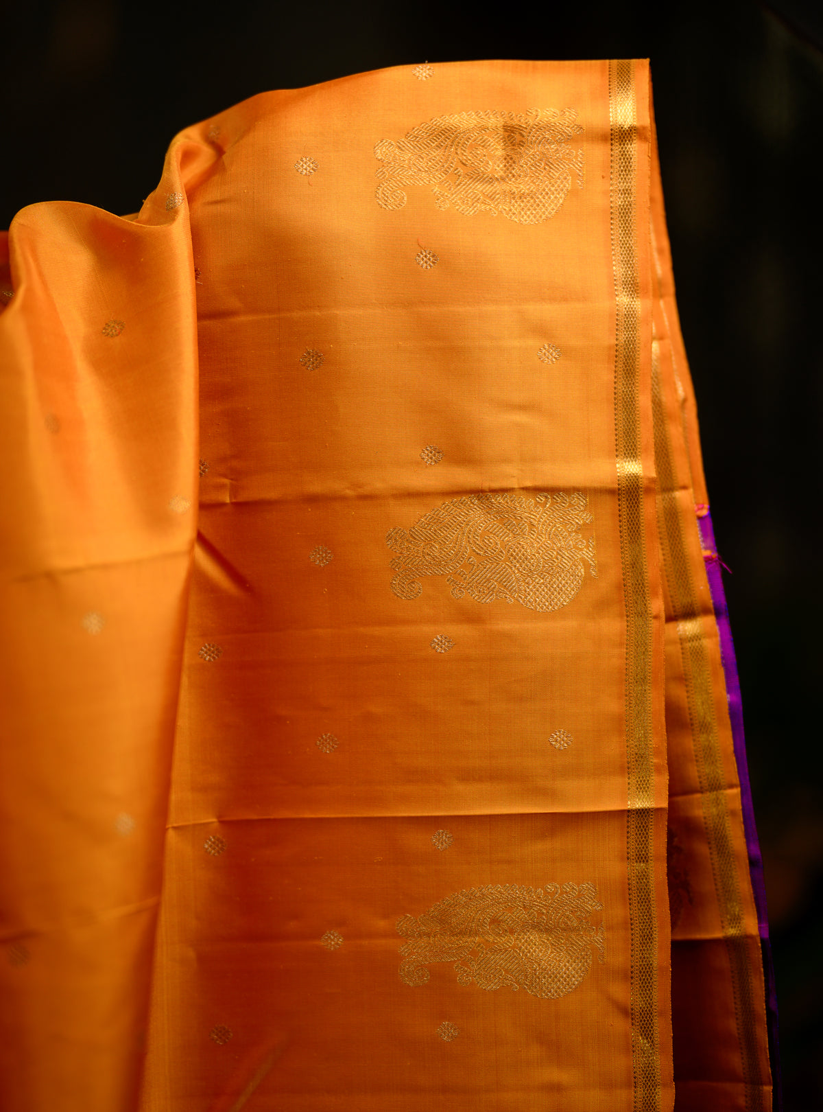 This is a gorgeous pure silk, pure zari Beetu Butta Kanchivaram in a rich mustard shade paired with a beautiful violet pallu.