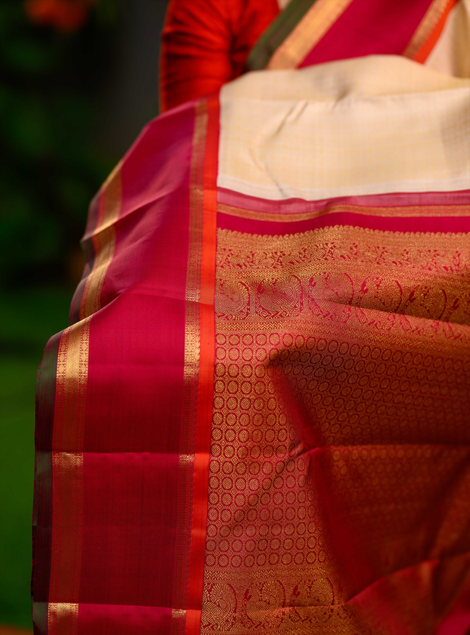 Laksham butta Korvai Kanjivaram in golden off white and pinkish red.
