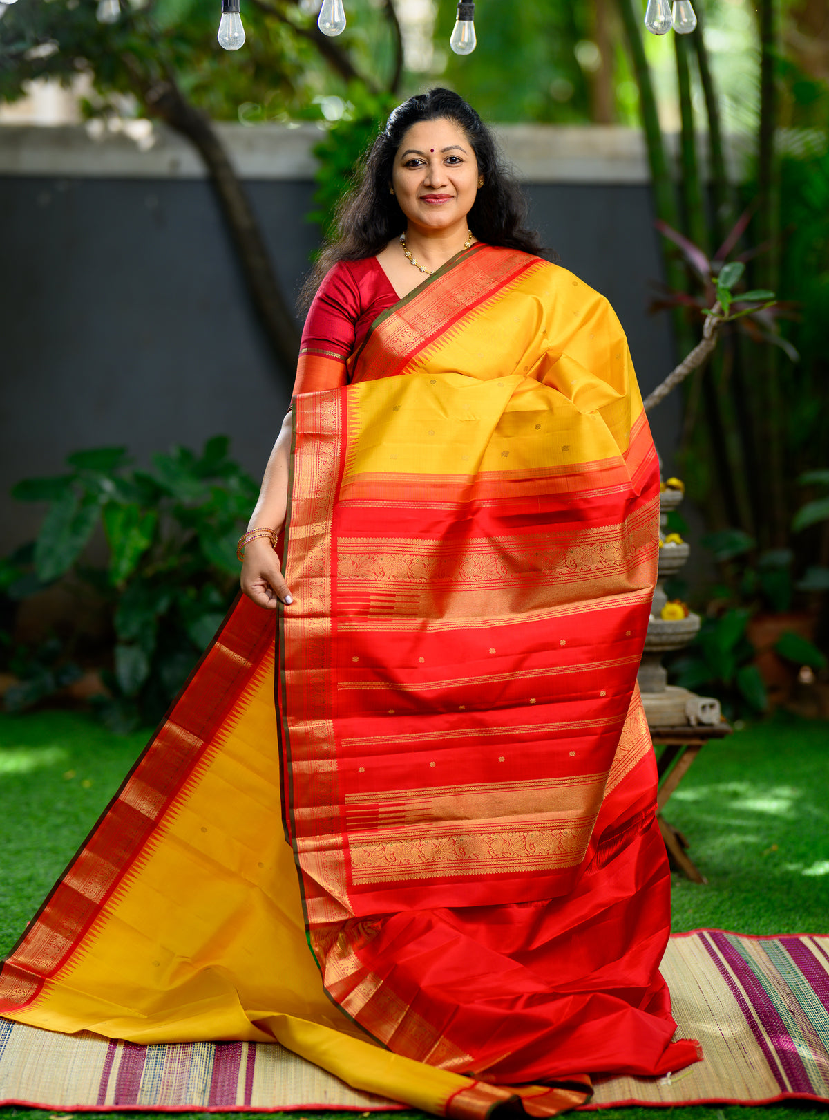 Pure silk, pure zari Korvai Kanchivaram in a beautiful turmeric yellow body, featuring elegant peacock and tiny Kamalam buttas.