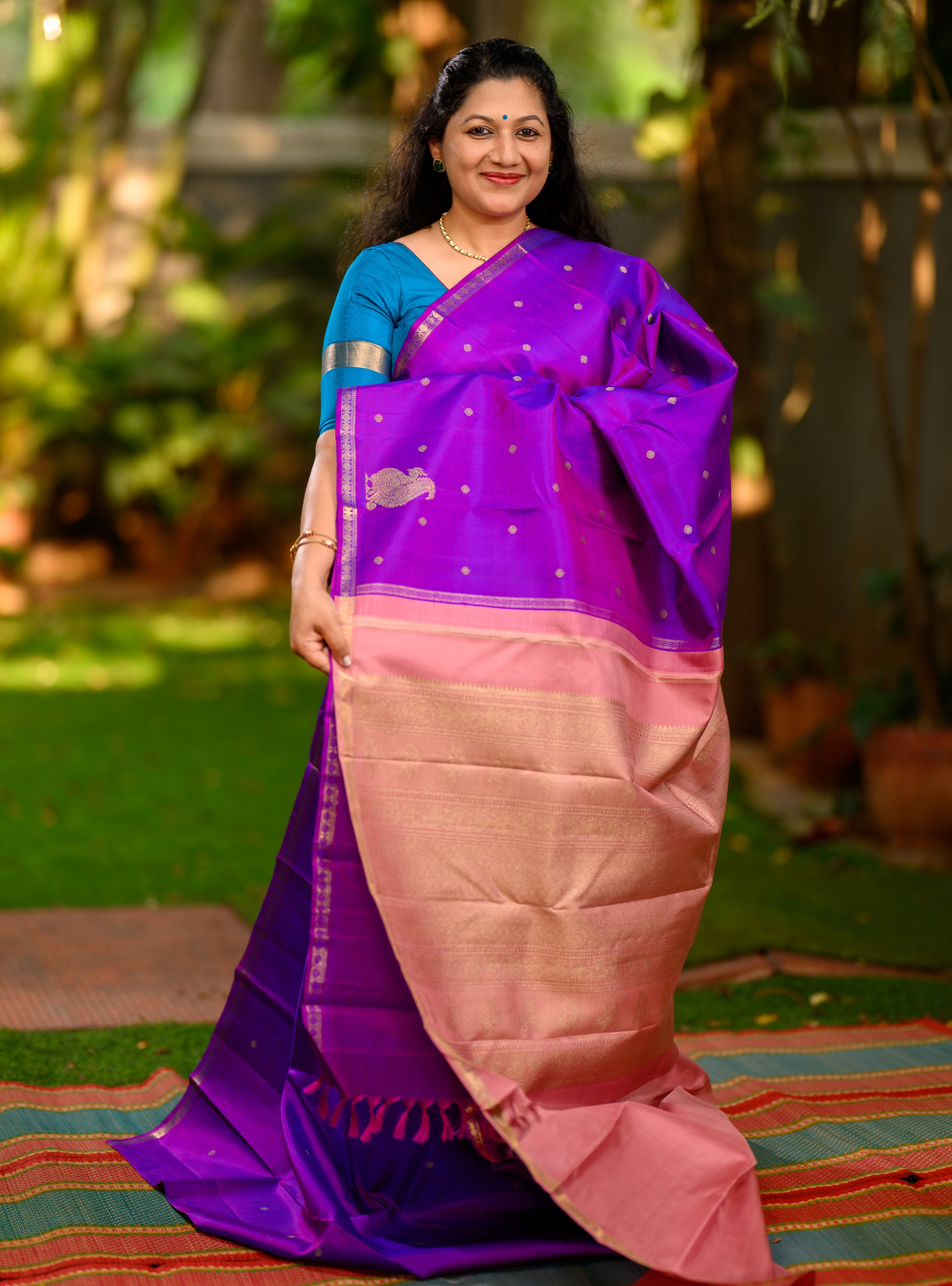 A beautiful pure silk, pure zari self Kanchivaram in a rich purple body with a soft pastel pink pallu.